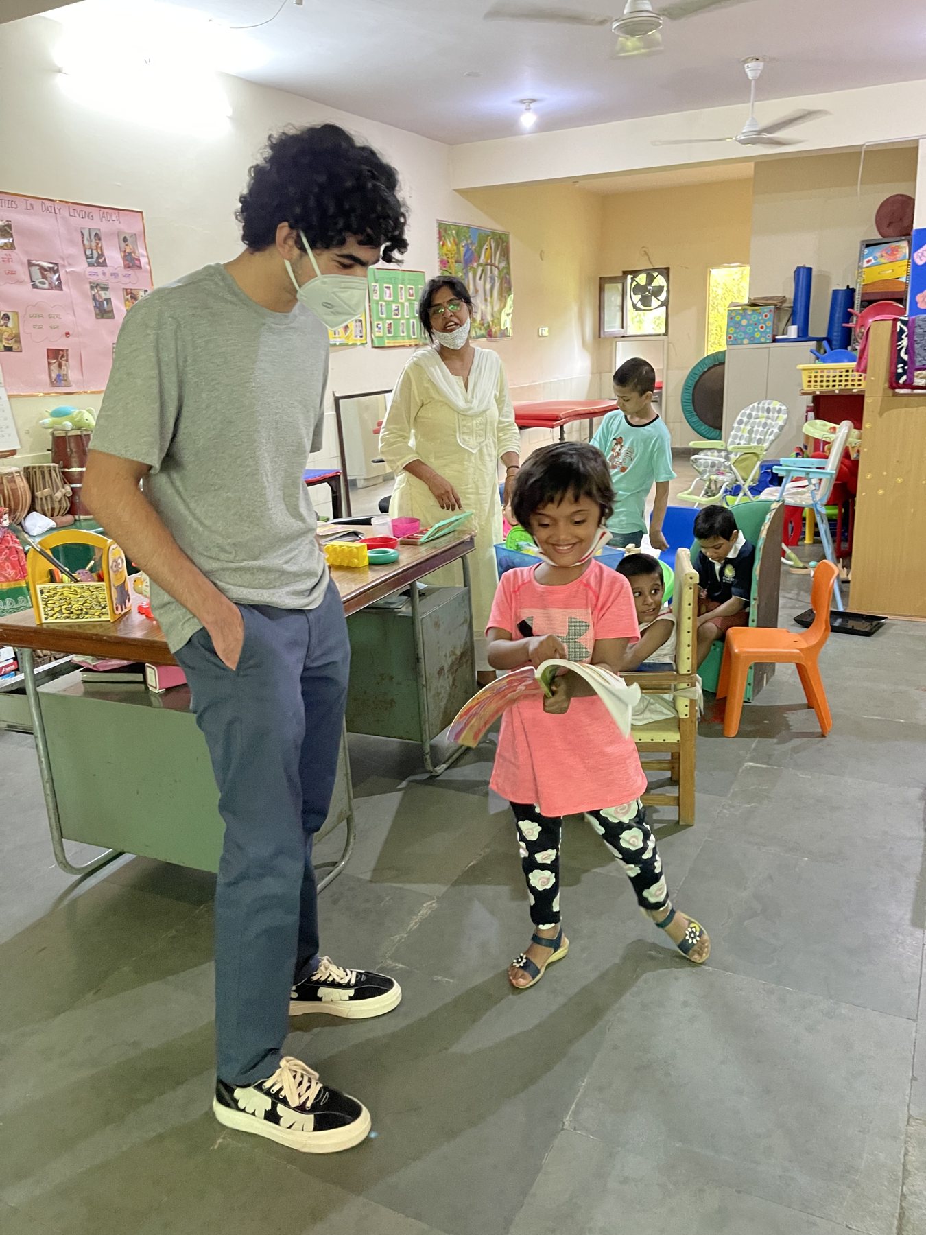 A RakshaDe volunteer in a Palna activity room with children and staff