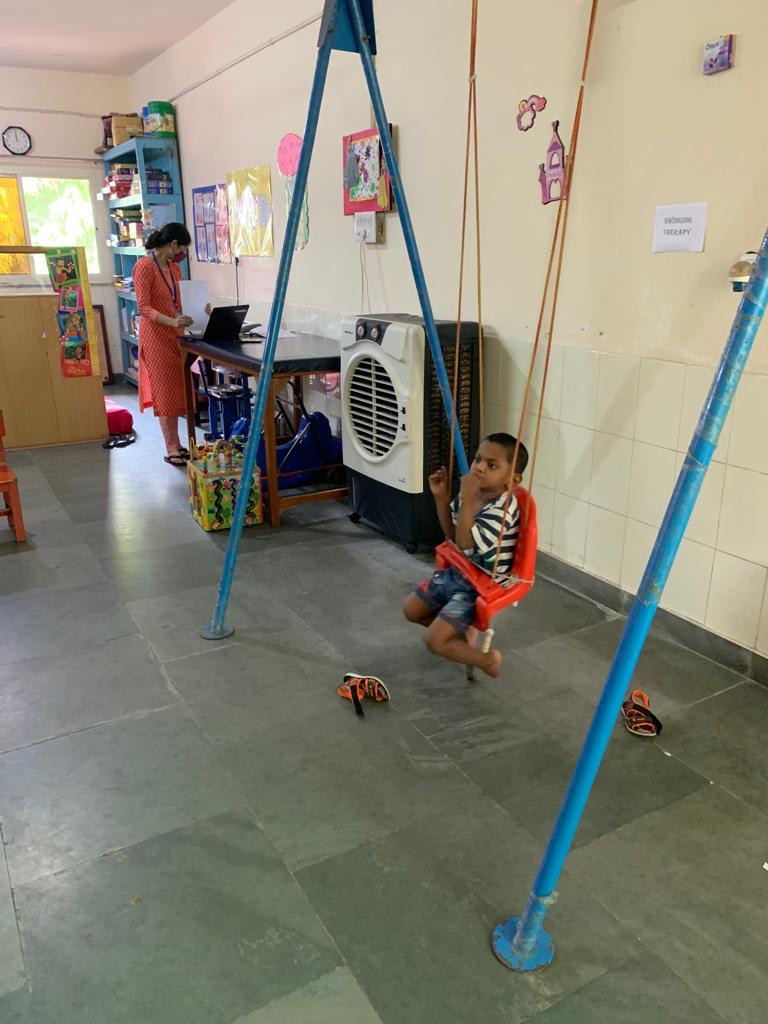 A child using a therapy swing at Palna